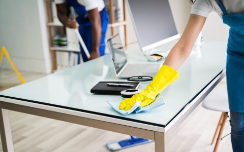 Male And Female Cleaners Cleaning Office